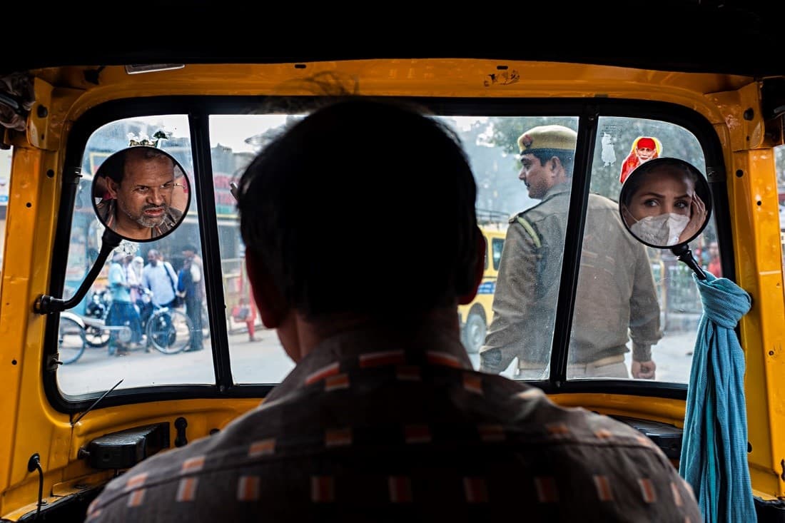 Woman's face in the mirror of rickshaw by Babak Kanaani, frame 1 of 1